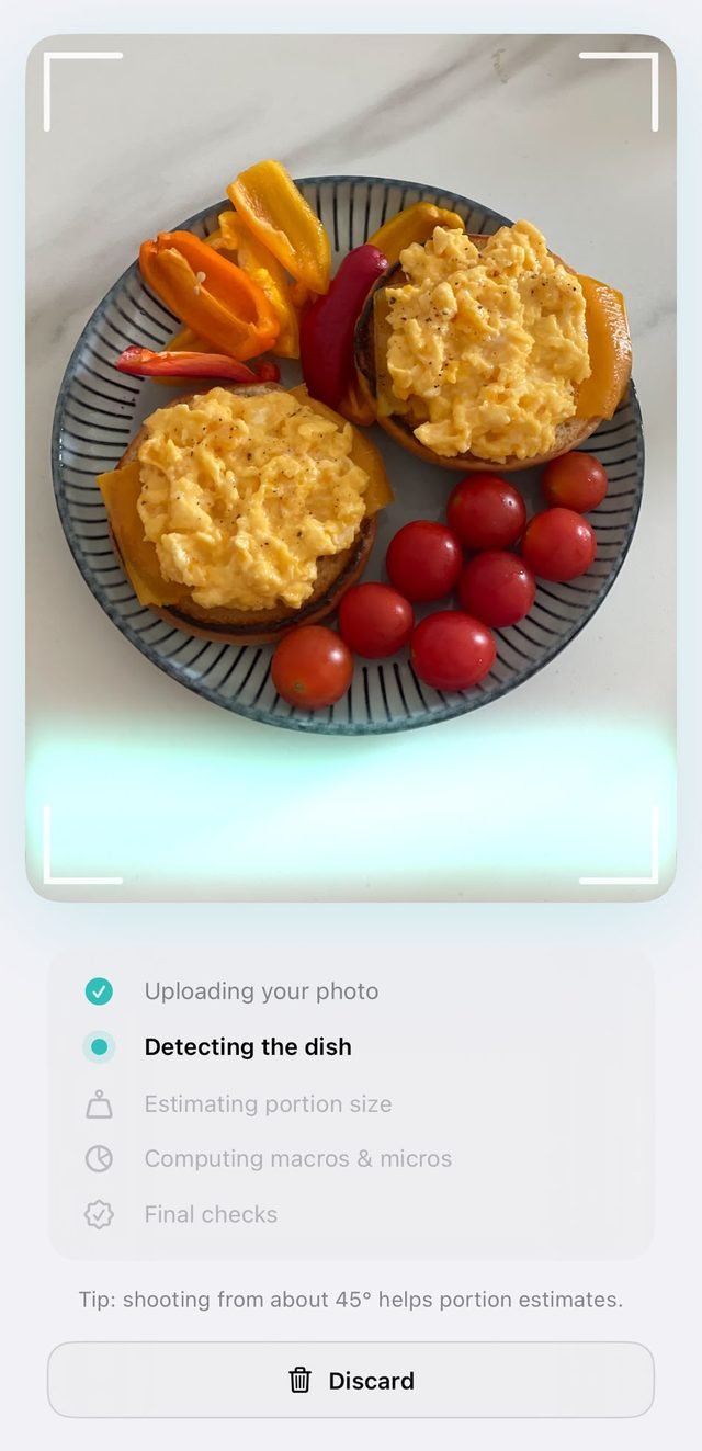 The scanning screen reading a plate of scrambled eggs, stepping through detecting the dish, estimating portion size and computing macros.